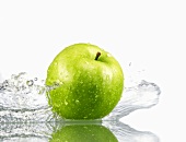Green apple with splashing water