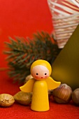 Wooden Christmas angel, nuts, fir branch