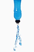 Blue energy drink squirting out of bottle