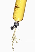Yellow energy drink splashing out of bottle
