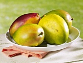 Several mangos on plate