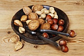 Assorted nuts in dish with nutcracker