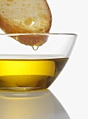 Olive oil dripping from slice of bread