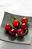 Several cherries on a square plate