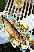 Barbecued trout with mushroom and potato skewers