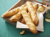 Several baguettes on wooden tray