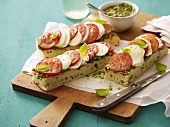 Focaccia topped with pesto, tomatoes and mozzarella