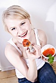 Woman eating chicken wings with sauce