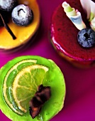 Assorted petit fours with blueberries and lime