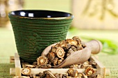 Saposhnikovia root in tea strainer, bowl of tea