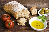 Still life with ciabatta, olive oil, olives and tomatoes