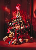 Christmas tree with red and gold decoration, baubles and lit candles