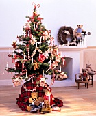 Christmas tree decorated with teddy bears, candy canes and lit candles