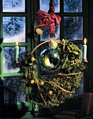 Christmas wreath with plaited decoration hanging on the wall