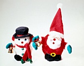 Santa Claus and snowman made of fabric on white background