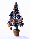 Christmas tree made of branches decorated with colourful glass pine cones