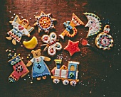 Colourful decorated gingerbread cookies on wooden surface, overhead view