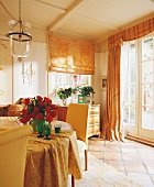 Living room with dining table, curtains, flower vase and chandelier