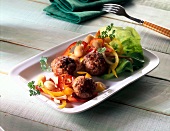 Meatballs with bell pepper salad and garnishing on plate