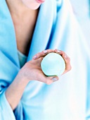 Close-up of woman's hands holding blue anti-stress ball
