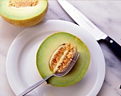 Close-up of halved galia melon on plate