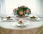 Laid table with ornamental cabbage and rose decoration
