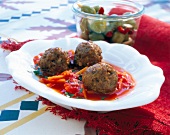 Meatball with tomato and carrot sauce in serving dish