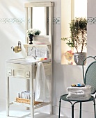 Small vanity with marble sink and mirror