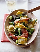 Ravioli with shrimps and green asparagus on plate