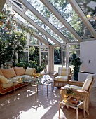 Seaweed sofa, cotto tiles and green plants in open room with glass doors