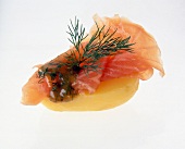 Salmon canape appetizer with boiled potato and dill on white background