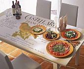 Tisch mit Antipasti und Wein, Tischdecke im Toskanischem Stil.