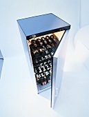 Several wine bottles in open wine cabinet