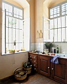 Küche mit großen Fenstern, massivem Holz u. gefliester Arbeitsplatte