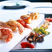 Various seafood with side dishes on a kitchen block