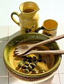 Green and yellow coloured ceramic dish, cup and jar with olive print