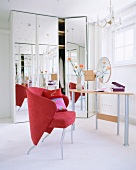 Vanity space with mirror, chairs and chandelier in dressing room