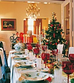 Christmas table decorated with red venetian glass and hand painted porcelain crockery