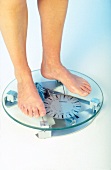 Close-up of woman's bare feet on weighing machine