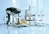 Stack of stainless steel utensils and cutlery on glass table
