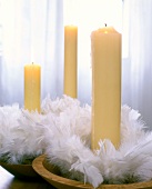 Close-up of candle with feather spring wreath