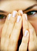 Extreme close-up of woman's fingernails wearing glitter nail paint