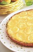 Lemon tart with citrus custard and pistachios on plate