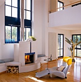 Living room with wooden flooring, fire place and recliner