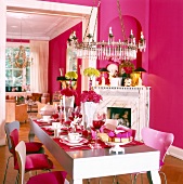 Dinning area decorated and set with pink furniture and large candlesticks