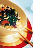 Close-up of stir fried chicken with mushrooms in bowl