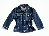 Dark denim jacket with silver studs on white background