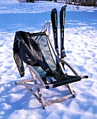 Recliner with sunglasses, gloves and sweaters in the snow
