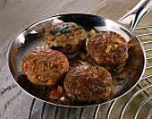 Four meatballs in pan