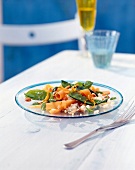 Mange tout and couscous with orange ginger sauce on plate